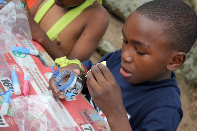Here's one of the crafts they made: stained glass candle holders for tea-light candles. I got to do the black outlines on all 50 of them before camp. 